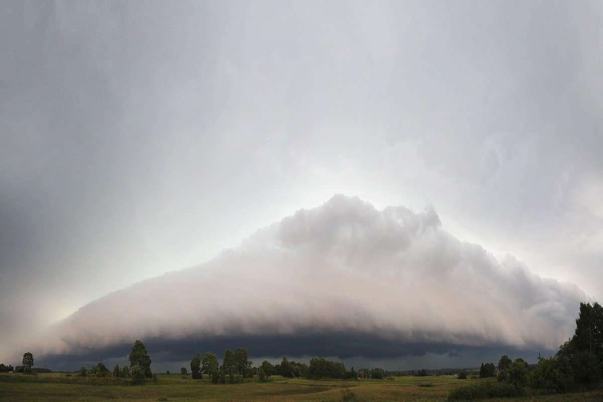 Mesmerizing Cloud Cascade Enchants Observers in the Jura Mountains 