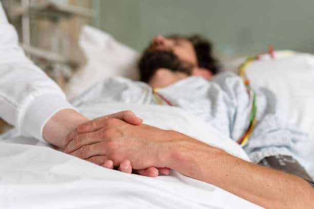 Healthcare-staff-caring-for-a-patient-in-hospital-bed-91a80ed131d3cdbafd775ed92d0f12da.jpg