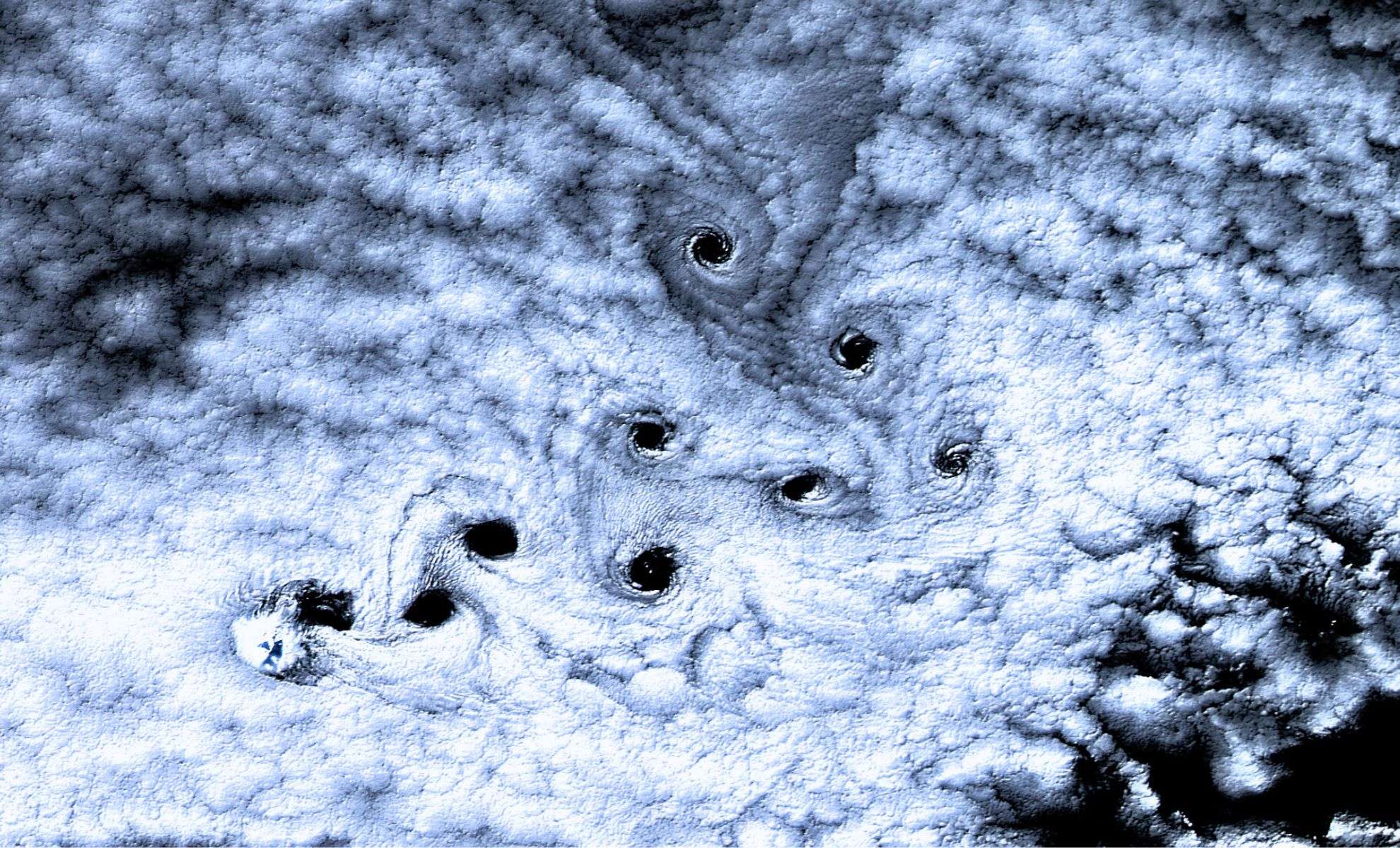 NASA Captures Stunning Spiral Cloud Formations Over Remote Antarctic Island 