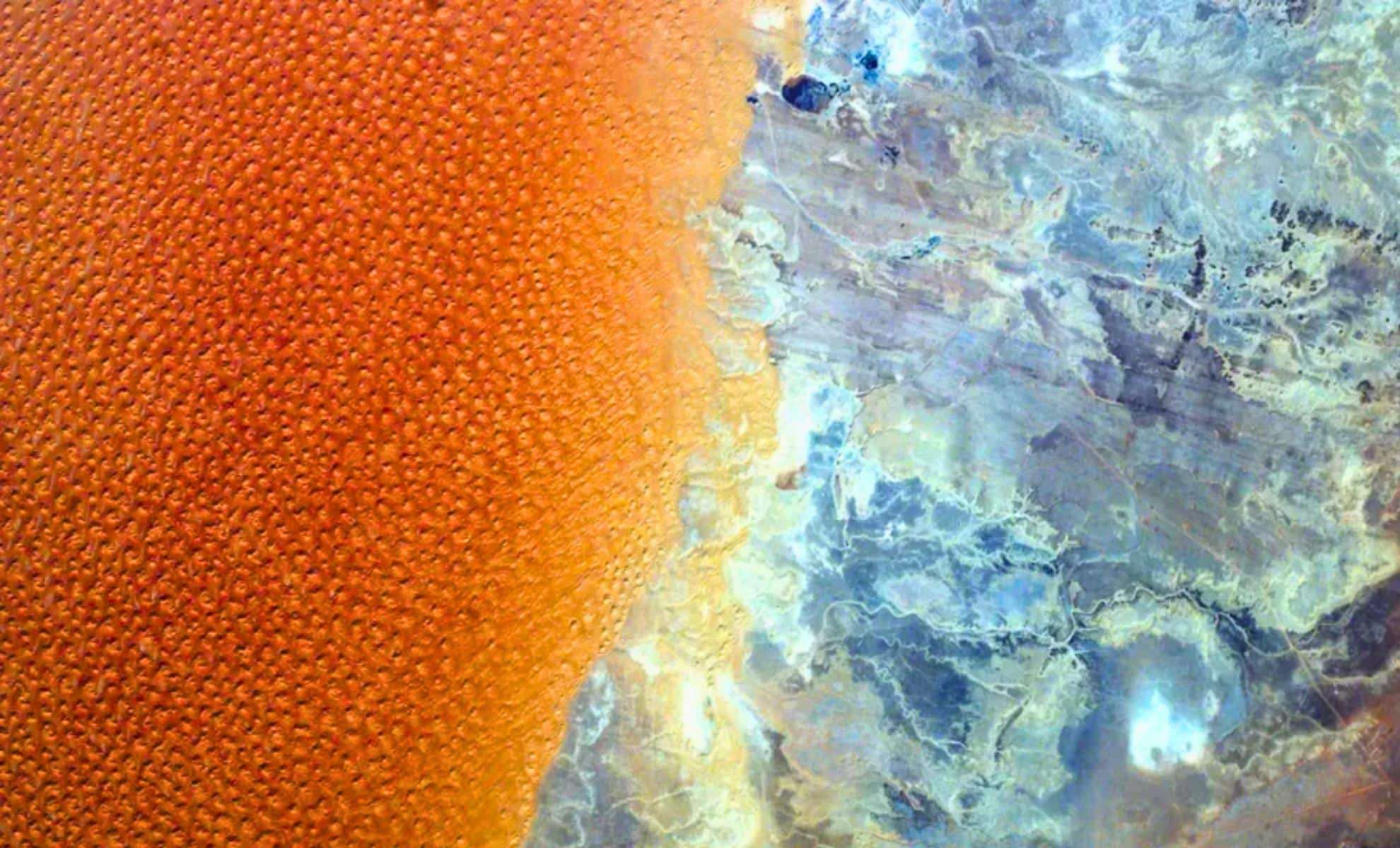 Striking Satellite Image Captures Sahara’s Star Dunes Meeting Barren Rocky Landscape 