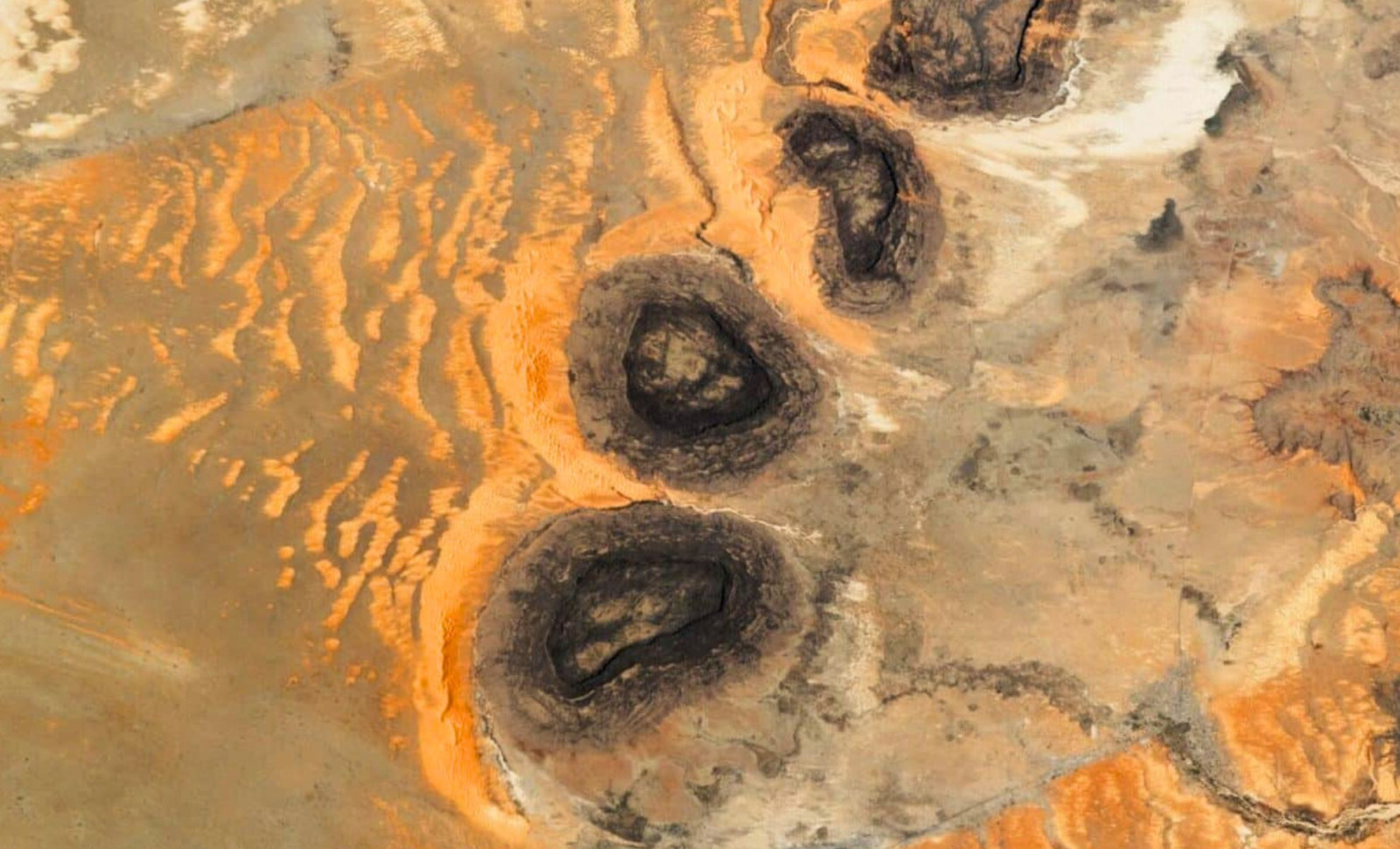 NASA Reveals Mysterious Black Mesas in Sahara with Distinct Sand Patterns 